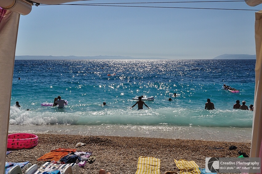 Beautiful beach of Podgora with people and pebbles