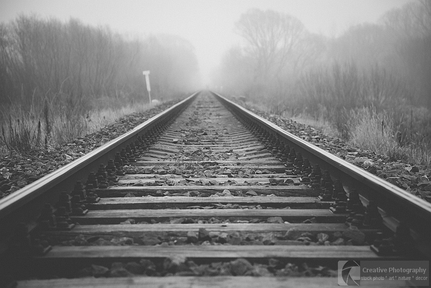 Railway going to the misty far away. Black and white photo