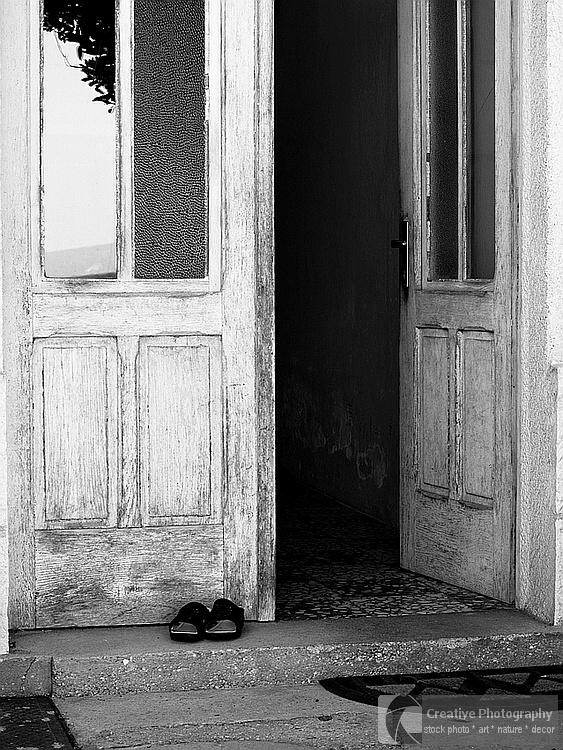 Opened door. Black and white photo