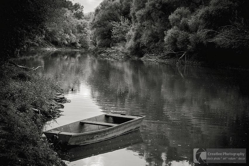 boat alone on the river, black and white photo