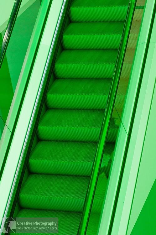Green escalator in abstract view