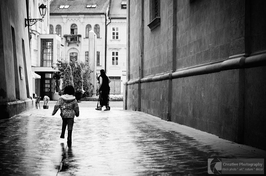 Young girl running to her mom. Black and white photo